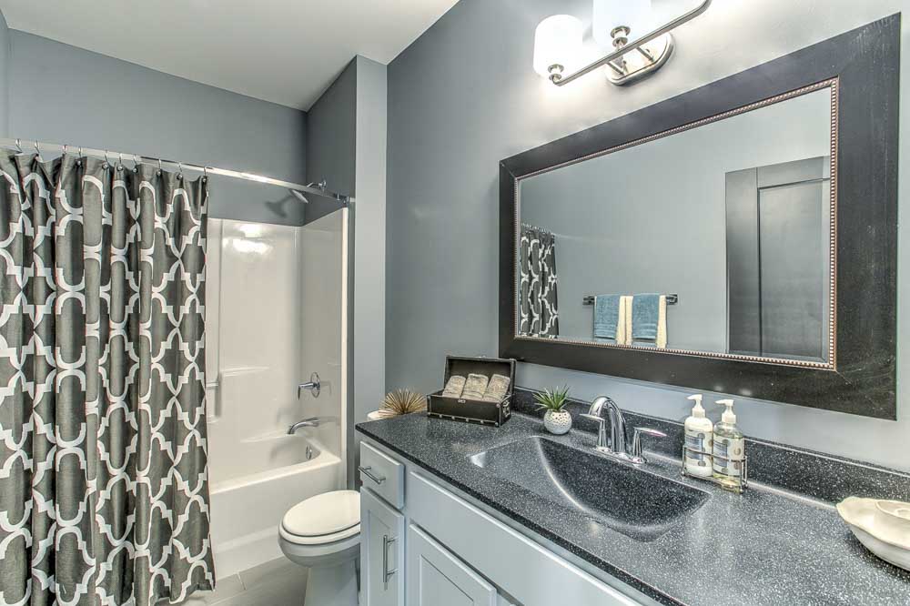 Bathroom with lots of cabinets for storage and a bathtub at The Helen