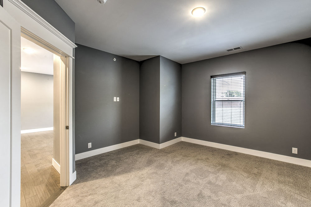 Large bedroom with natural light at The Helen
