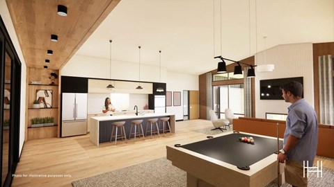 A man is standing in a modern kitchen with a pool table.