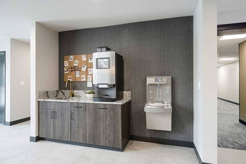 The clubhouse coffee bar with coffee machine and smart water fountain