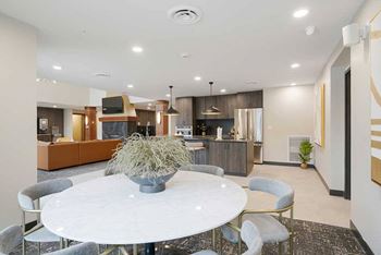 The clubhouse kitchen featuring a dining table and chairs