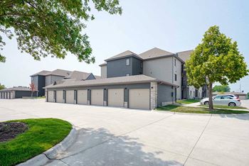 a row of detached garages next to an apartment building