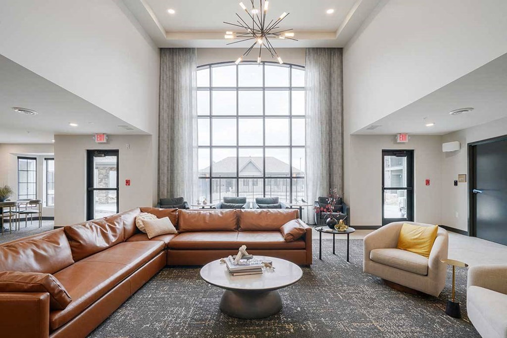 The clubhouse lounge with a floor to ceiling window and lounge seating