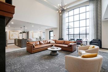 The clubhouse lounge featuring a floor to ceiling window and plenty of seating options