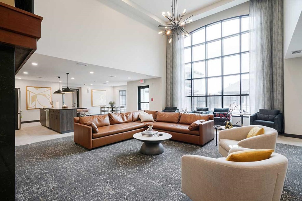 The clubhouse lounge featuring a floor to ceiling window and plenty of seating options