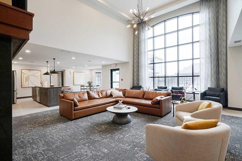 The clubhouse lounge featuring a floor to ceiling window and plenty of seating options