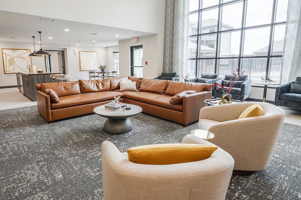 The clubhouse lounge central seating area with a sectional and armchairs