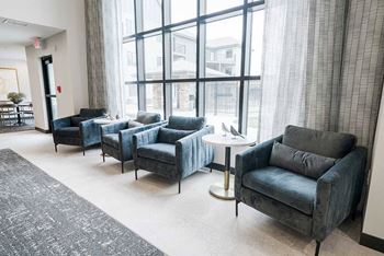 A close up on some of the plush armchairs in the clubhouse lounge