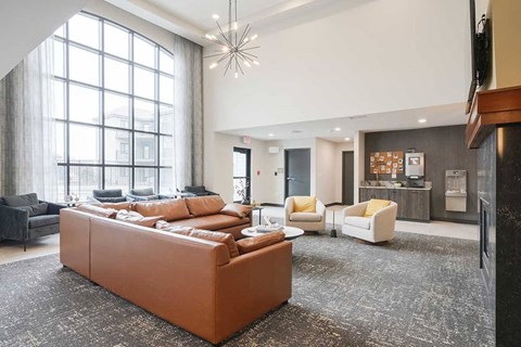 The clubhouse lounge featuring a floor to ceiling window and plenty of seating options