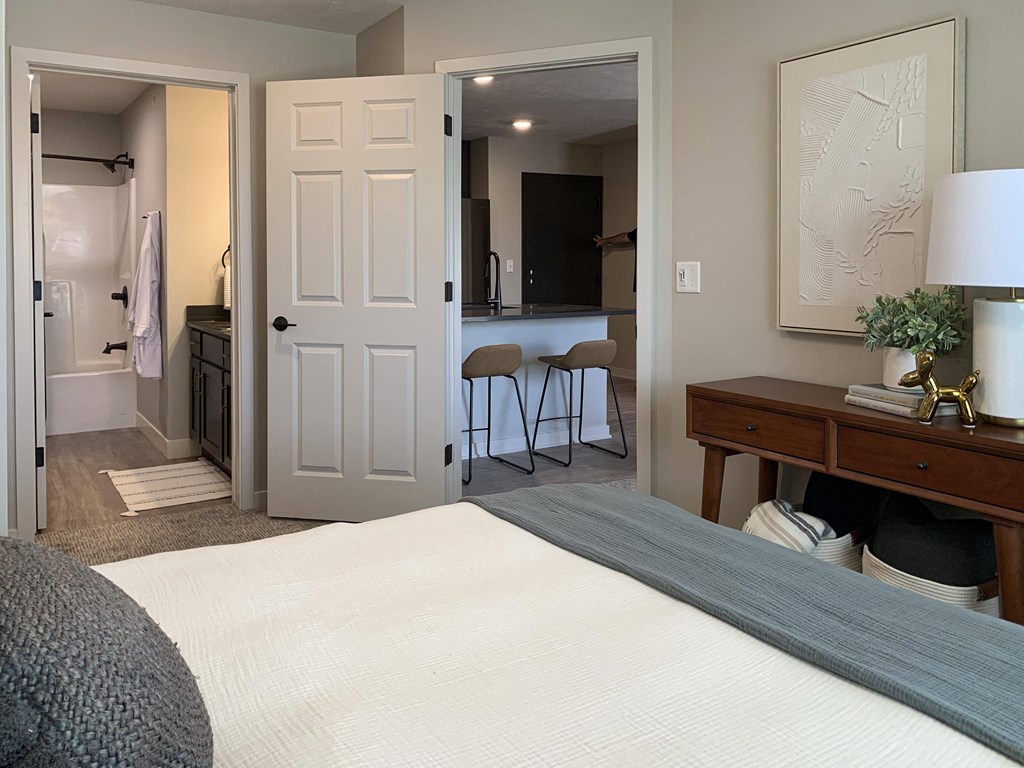 a bedroom with a bed and a desk