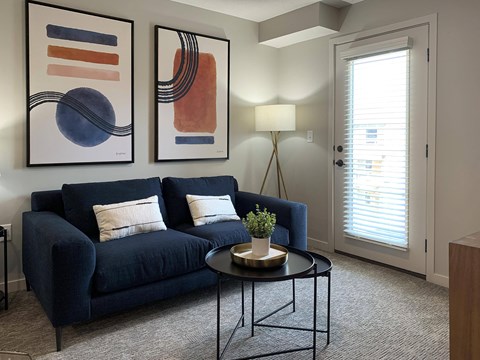 a living room with a blue couch and a coffee table