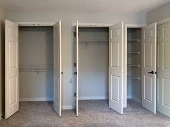 three bedroom closet doors are open