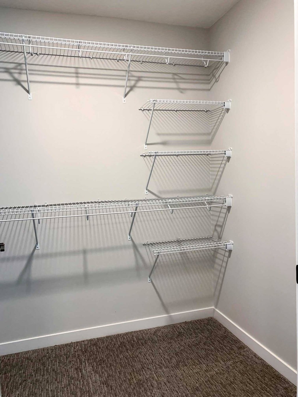 a walk in closet with extra shelving for storage
