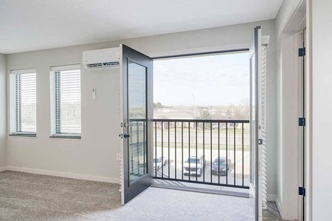 A living room with double doors to a Juliet balcony