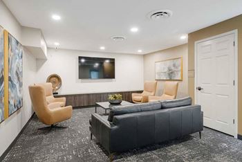 The theater room with private seating a tv