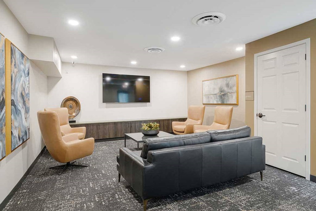 The theater room with private seating a tv