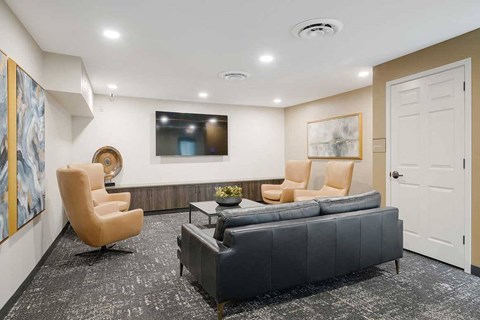 The theater room with private seating a tv