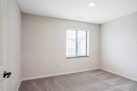 The second bedroom in the Dove floorplan featuring a window