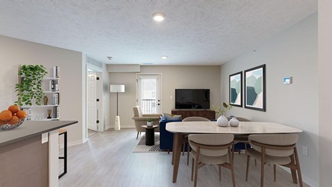 A living room and dining space with a TV, chair, couch, and table with four chairs