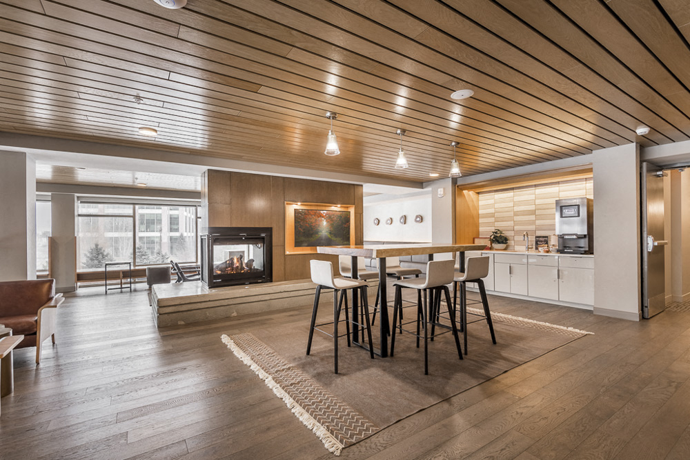 Table and fireplace near coffee bar in The Preserve's clubhouse