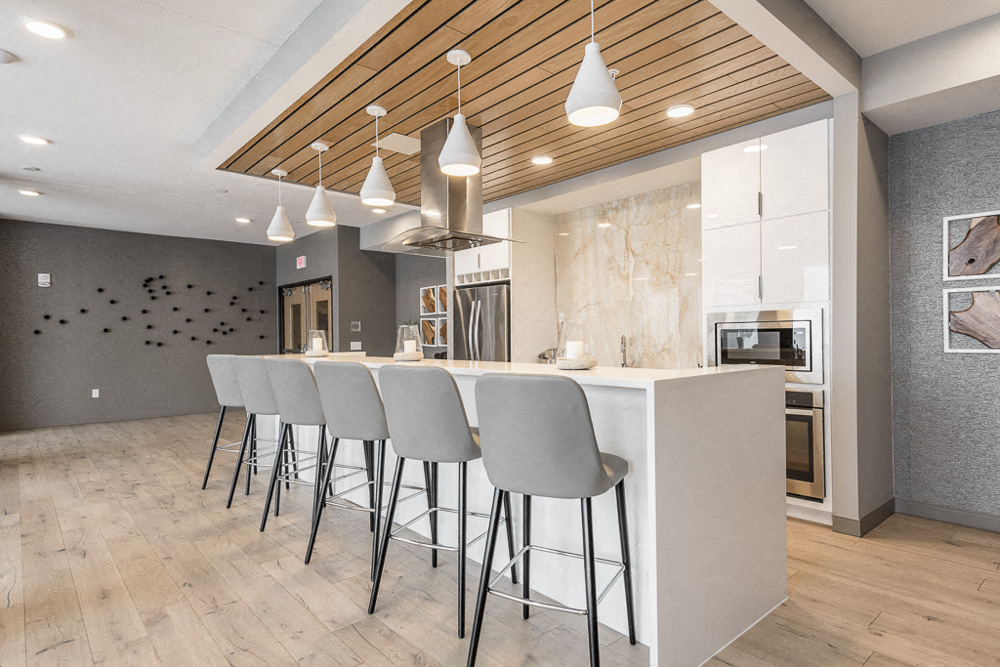 View of gourmet kitchen and bar stools in amenity space at The Preserve in Bloomington