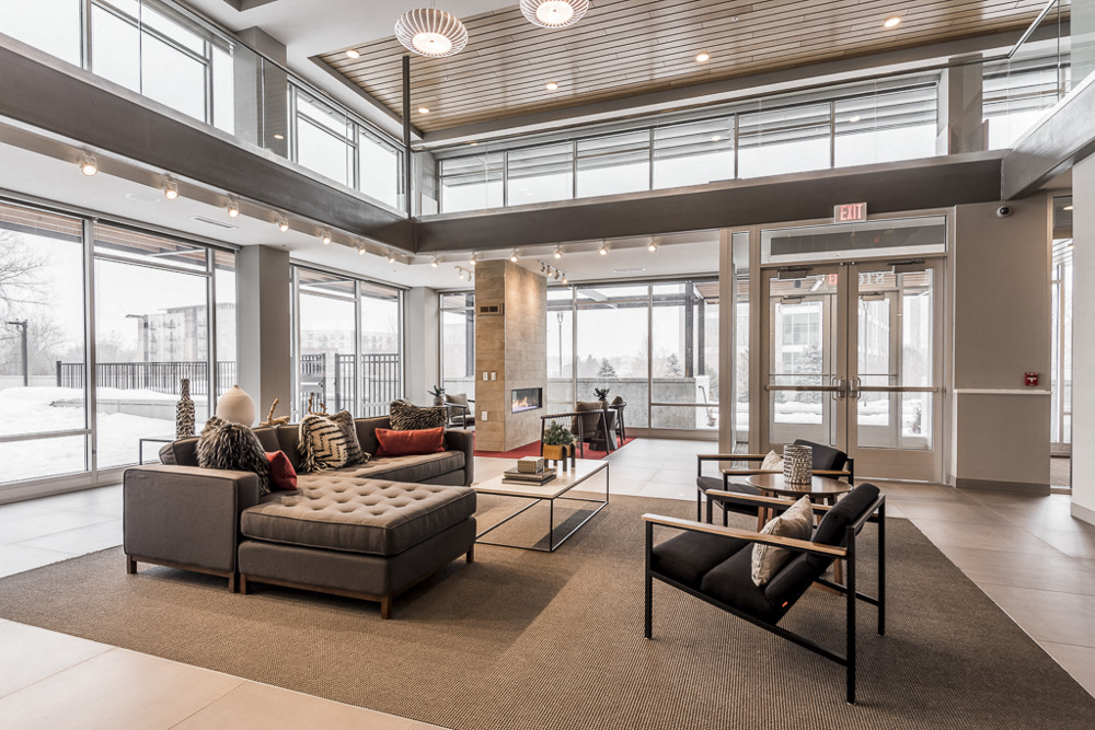 View of clubhouse interior with 2-story windows and couches