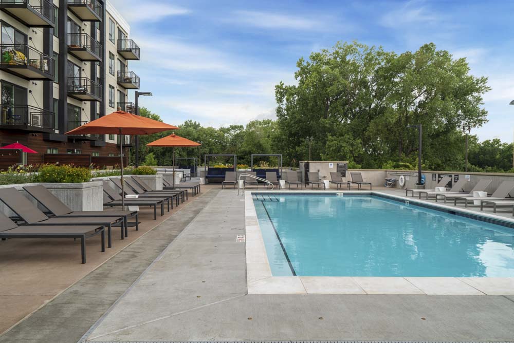 Resort-style pool with beach lounge chairs.