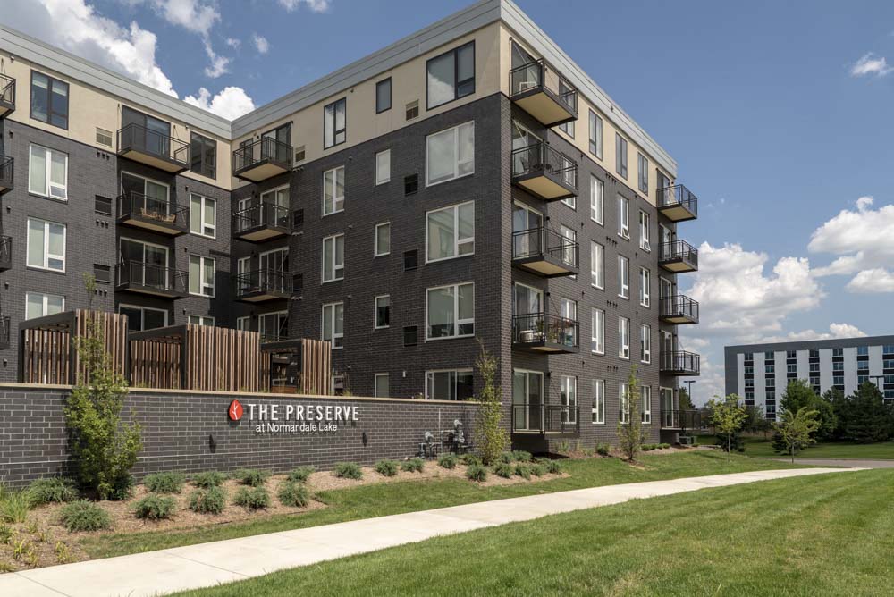 Exterior of the Preserve at Normandale Lake with green space.