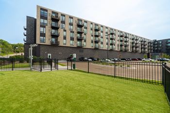 The Rowan Apartment building exterior with heated turf dog park