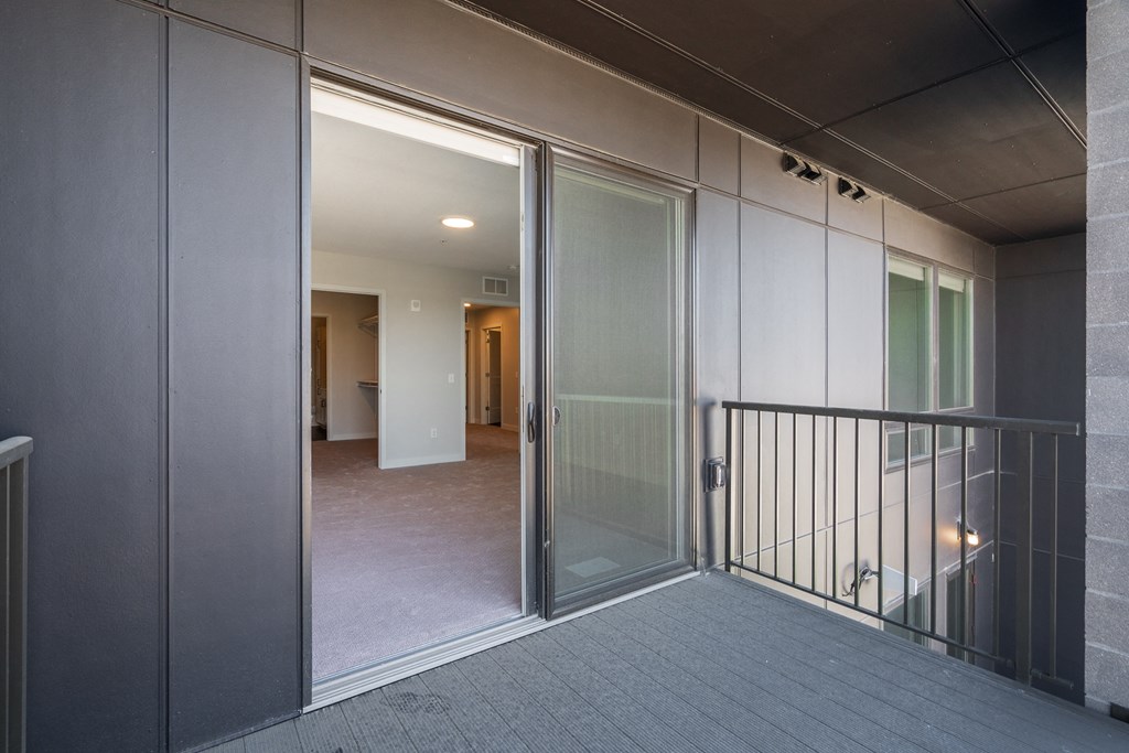large balcony with sliding screen and glass door