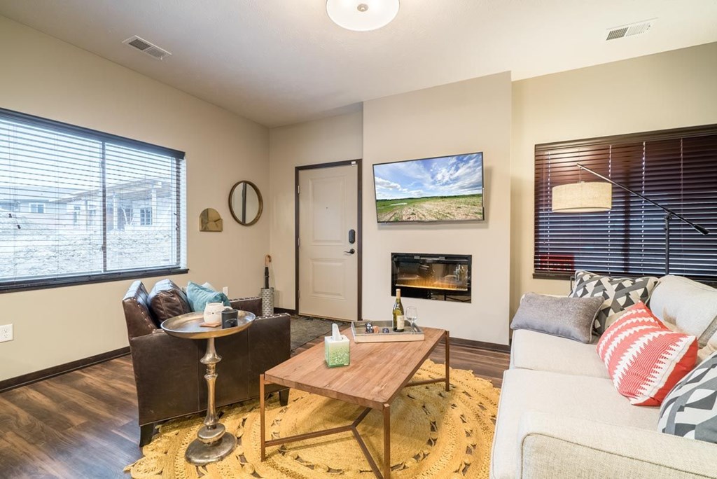 A living room with a fireplace and a painting on the wall.
