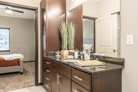 A bathroom with a vanity and a mirror.
