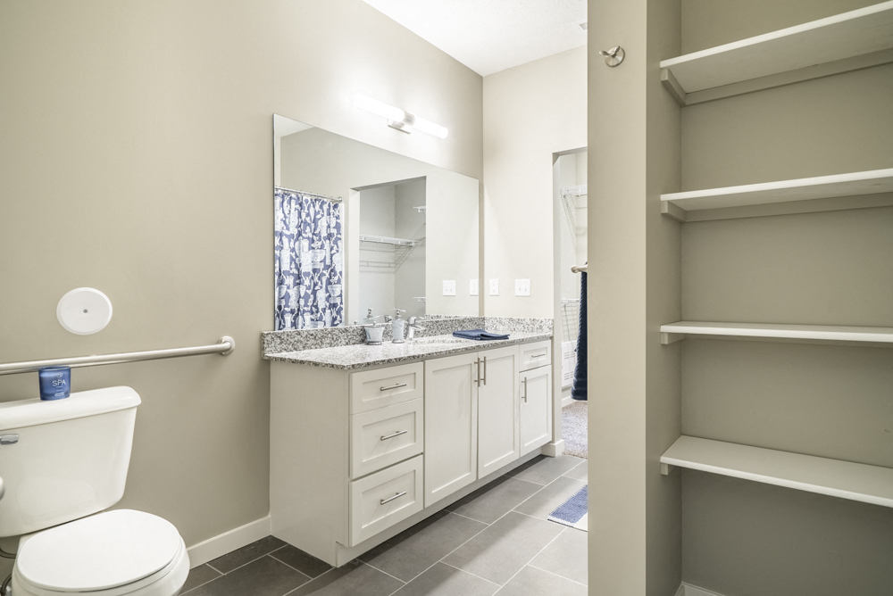 Interiors-Large master bathroom with built-in shelving