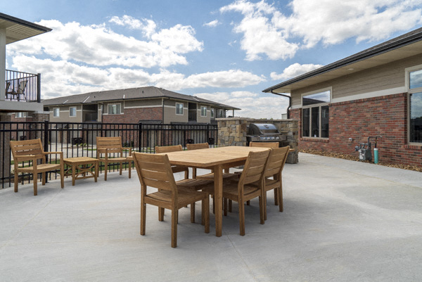 Outdoor tables and grills near the pool at The Villas at Falling Waters townhomes in west Omaha