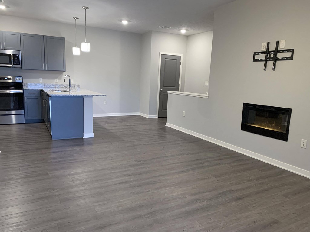 spacious living and dining room with fireplace for extra warmth at the villas at mahoney park