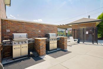 outdoor grilling station with two grills and cooking area