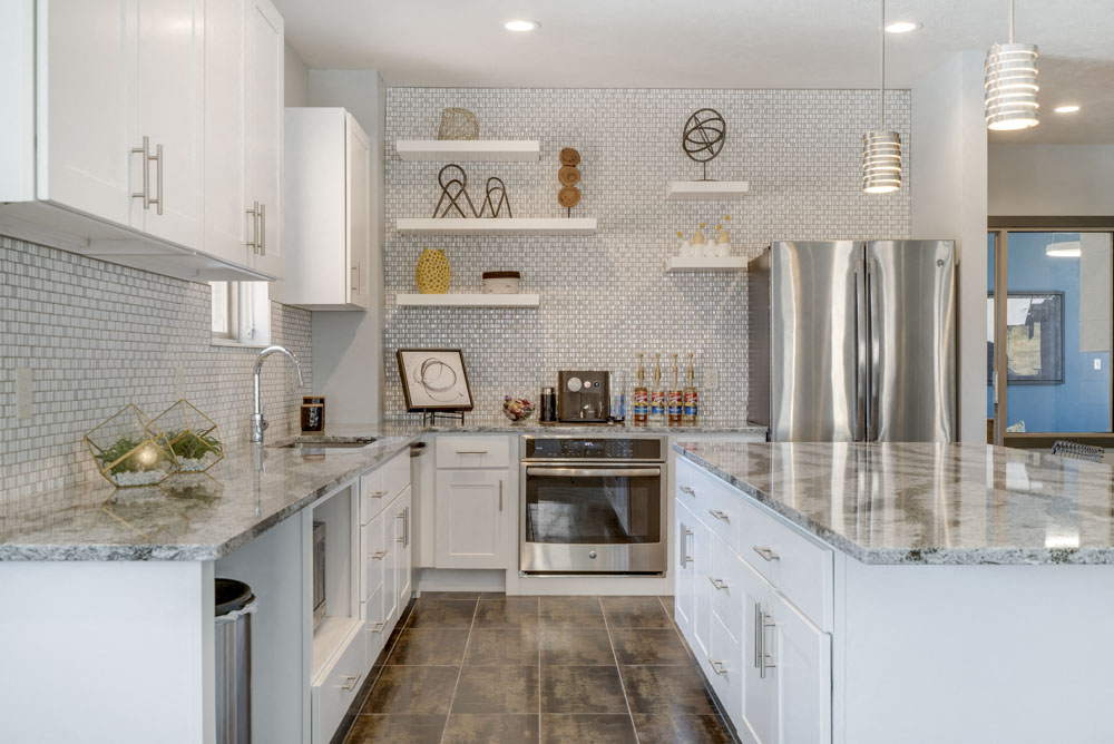 Full kitchen with granite countertops in clubhouse at The Villas at Mahoney Park townhomes in north Lincoln NE 68507