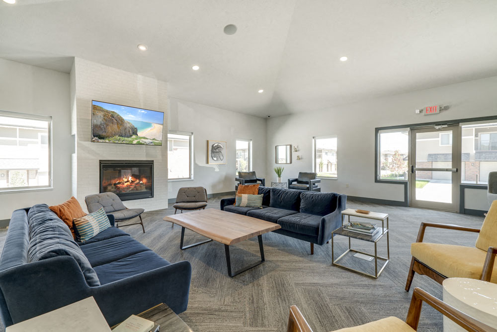 Couches near the fireplace in the clubhouse at The Villas at Mahoney Park