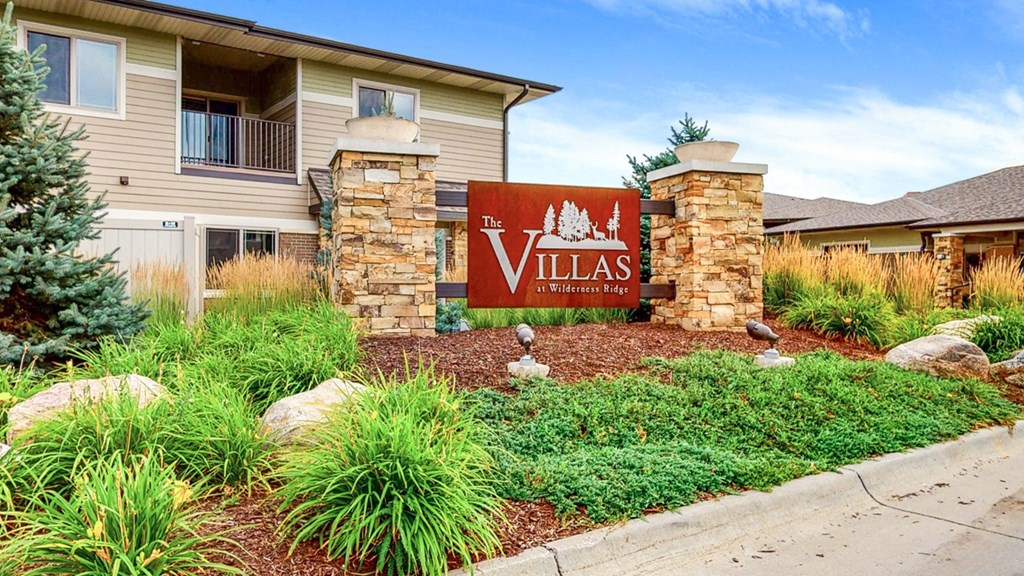 landscaped median with sign reading The Villas at Wilderness Ridge