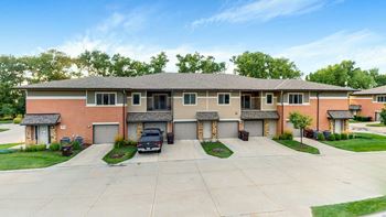 A large villa apartment building with driveways and street in front