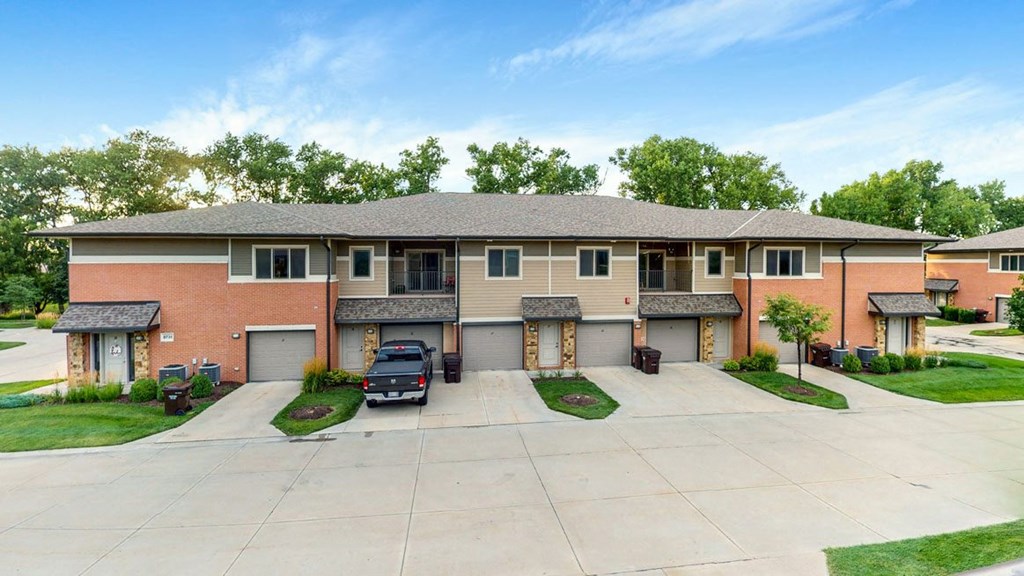 A large villa apartment building with driveways and street in front
