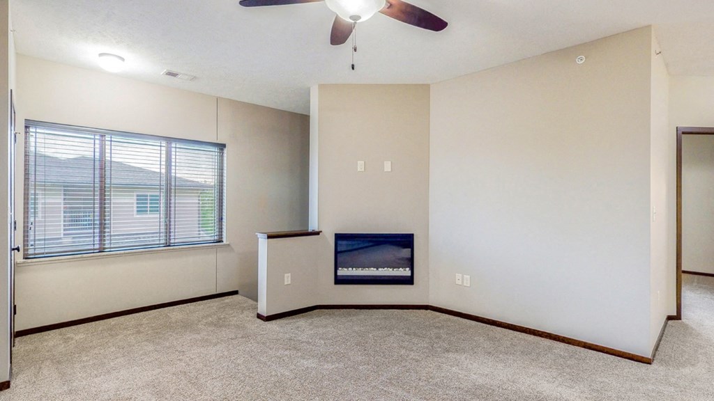 Living area with modern fireplace at The Villas at Wilderness Ridge luxury apartments in southwest Lincoln NE 68512