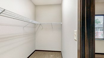 Walk in closet in the bedroom at The Villas at Wilderness Ridge luxury apartments in southwest Lincoln NE 68512 - Photo Gallery 69