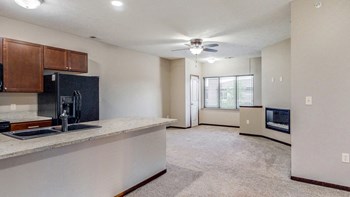 Open floor plan with modern fireplace at The Villas at Wilderness Ridge luxury apartments in southwest Lincoln NE 68512 - Photo Gallery 67