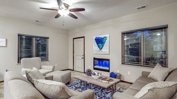 The spacious living area in the Cedar features an electric fireplace - Photo Gallery 58