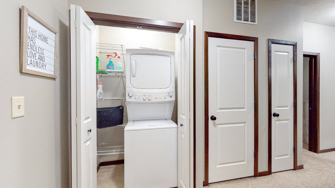The Cedar features a full-size stacked washer and dryer. - Photo Gallery 55