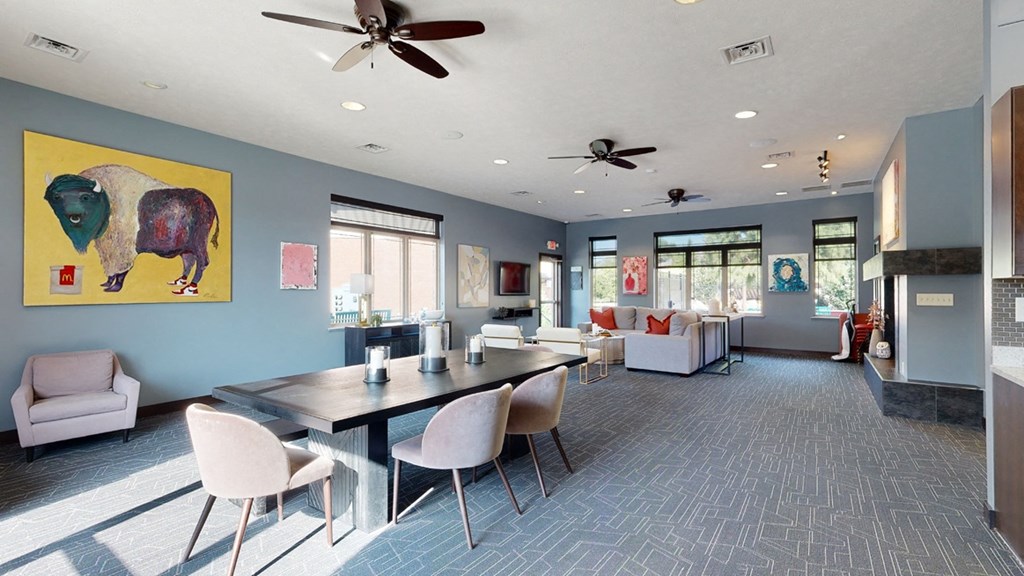 Clubhouse lounge with blue walls and a large yellow painting on the wall