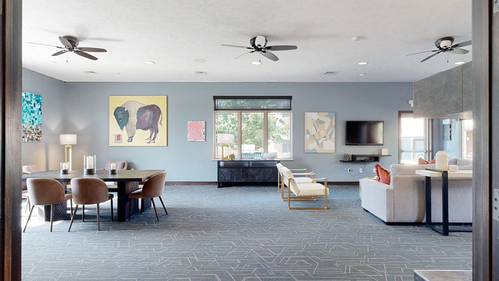 the clubhouse lounge with a table and chairs and a couch