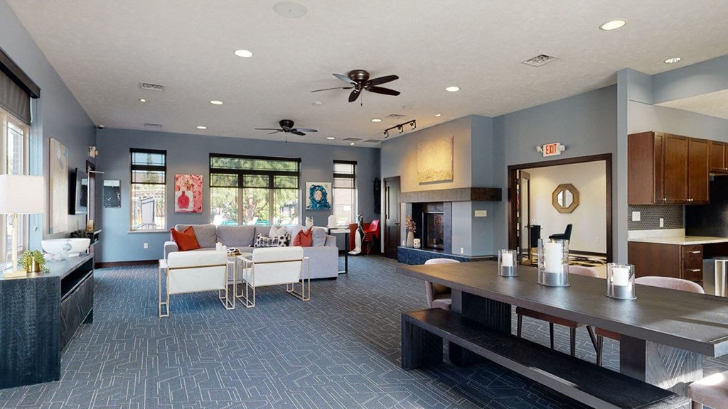 Clubhouse living room with a fireplace and a ceiling fan