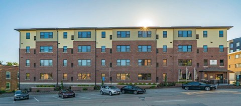 The Helen apartment building exterior with street parking